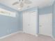 A bedroom featuring a ceiling fan, tile flooring, and sliding door closet at 1069 Harbour Cape Pl, Punta Gorda, FL 33983