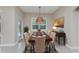 Formal dining room featuring a wooden table, tufted chairs, and a decorative pendant light fixture at 1069 Harbour Cape Pl, Punta Gorda, FL 33983