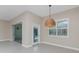 Dining area with an elegant woven pendant light, sliding doors, and neutral paint at 1069 Harbour Cape Pl, Punta Gorda, FL 33983