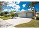 Beautiful home featuring a three-car garage, well-manicured lawn, and a circular driveway at 1069 Harbour Cape Pl, Punta Gorda, FL 33983