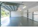 Spacious garage with epoxy flooring, bright lighting, and ample space for vehicles and storage solutions at 1069 Harbour Cape Pl, Punta Gorda, FL 33983