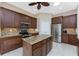 The open kitchen offers dark cabinets, granite countertops, stainless steel appliances, and tiled floors at 1069 Harbour Cape Pl, Punta Gorda, FL 33983