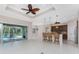 Modern open kitchen and bar area with wicker chairs, pendant lighting and stainless steel appliances at 1069 Harbour Cape Pl, Punta Gorda, FL 33983