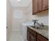 Well-equipped laundry room features a sink with granite countertop and ample cabinet storage at 1069 Harbour Cape Pl, Punta Gorda, FL 33983