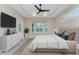 Main bedroom featuring a ceiling fan, large windows with shutters, and a decorative rug at 1069 Harbour Cape Pl, Punta Gorda, FL 33983