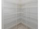 Walk-in pantry with white wire shelving for organized storage of food items and kitchen essentials at 1069 Harbour Cape Pl, Punta Gorda, FL 33983