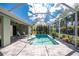 Inviting screened pool area with pavers, ample seating, and lush tropical surroundings at 1069 Harbour Cape Pl, Punta Gorda, FL 33983