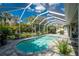 Sparkling pool surrounded by tropical landscaping and a screened enclosure at 1069 Harbour Cape Pl, Punta Gorda, FL 33983