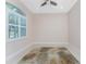 A bright room with tile flooring, ceiling fan and plantation shutters at 1069 Harbour Cape Pl, Punta Gorda, FL 33983