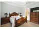 Bright bedroom with wooden bed, dresser, and ensuite bathroom access at 11101 Sandhill Preserve Dr, Sarasota, FL 34238