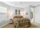 Bedroom with full bed, plantation shutters, and tropical decor at 11101 Sandhill Preserve Dr, Sarasota, FL 34238