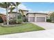 Spacious home exterior with a two-car garage and manicured lawn at 11101 Sandhill Preserve Dr, Sarasota, FL 34238