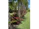 Beautiful landscaping features mature palm trees and vibrant flowers along a well-maintained lawn at 11101 Sandhill Preserve Dr, Sarasota, FL 34238