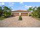 Two-car garage with paver driveway and nicely landscaped front yard at 114 Babbling Brook Run, Bradenton, FL 34212