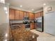 Modern kitchen with stainless steel appliances and granite countertops at 114 Babbling Brook Run, Bradenton, FL 34212