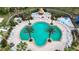 Large community pool with plenty of lounge chairs and a tiki hut at 11458 Saffron Ct, Venice, FL 34292