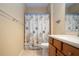 Bathroom with shower/tub combo, wood vanity, and starfish-themed decor at 11458 Saffron Ct, Venice, FL 34292