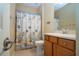 Bathroom with shower/tub combo, wood vanity, and starfish-themed decor at 11458 Saffron Ct, Venice, FL 34292