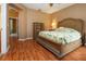 Bright bedroom featuring a king-size bed and wood flooring at 11458 Saffron Ct, Venice, FL 34292