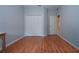 Bedroom with wood floors and double doors leading to closet at 11458 Saffron Ct, Venice, FL 34292