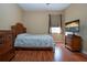 Bedroom with wood floors, wood furniture, and large window at 11458 Saffron Ct, Venice, FL 34292