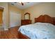 Bedroom with wood floors, walk-in closet, and wood furniture at 11458 Saffron Ct, Venice, FL 34292