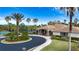 Community clubhouse with tennis courts and circular drive at 11458 Saffron Ct, Venice, FL 34292