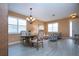 Elegant dining area with chandelier and light-colored wood furniture at 11458 Saffron Ct, Venice, FL 34292