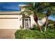 House with white door and lush landscaping in the front at 11458 Saffron Ct, Venice, FL 34292