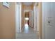 Hallway with light wood-look flooring and bedroom access at 11458 Saffron Ct, Venice, FL 34292