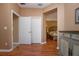 Light-filled hallway with wood-look flooring and access to bedrooms at 11458 Saffron Ct, Venice, FL 34292