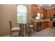 Kitchen breakfast nook with glass table and two chairs at 11458 Saffron Ct, Venice, FL 34292