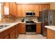 Kitchen area with stainless steel appliances and wood cabinets at 11458 Saffron Ct, Venice, FL 34292