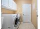 Laundry room with washer, dryer, cabinets, and utility sink at 11458 Saffron Ct, Venice, FL 34292