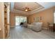 Living room with built-in shelving, hardwood floors, and access to a screened patio at 11458 Saffron Ct, Venice, FL 34292