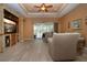 Living room with built-in shelving, hardwood floors, and access to a screened patio at 11458 Saffron Ct, Venice, FL 34292