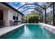 Inviting screened pool with a tranquil waterfall feature at 11458 Saffron Ct, Venice, FL 34292