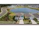 Aerial view of a two-story house with a lake and community in the background at 12977 Twin Bridges Dr, Riverview, FL 33579