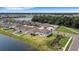 Aerial view of a house and community by a lake at 12977 Twin Bridges Dr, Riverview, FL 33579