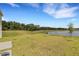 Backyard with pond and lush green grass at 12977 Twin Bridges Dr, Riverview, FL 33579