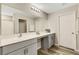 Double vanity bathroom with gray cabinets and a large mirror at 12977 Twin Bridges Dr, Riverview, FL 33579