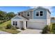 Two-story house with light blue and beige siding at 12977 Twin Bridges Dr, Riverview, FL 33579