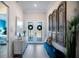 Light-filled entryway, featuring decorative wood accents and a bench at 13299 Rinella St, Venice, FL 34293