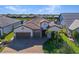 Two-story house with tile roof, two-car garage, and landscaping at 13299 Rinella St, Venice, FL 34293