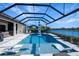 Relaxing pool and spa with covered lanai overlooking a lake at 13299 Rinella St, Venice, FL 34293