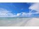 Expansive beach view with clear water and fluffy clouds at 1336 Benjamin Franklin Dr # 1F, Sarasota, FL 34236