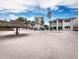 Beachfront property with thatch umbrellas and lounge chairs at 1336 Benjamin Franklin Dr # 1F, Sarasota, FL 34236