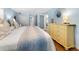 Serene bedroom with large bed, dresser, and access to bathroom at 1336 Benjamin Franklin Dr # 1F, Sarasota, FL 34236