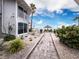 Brick pathway leads to beach; lush landscaping at 1336 Benjamin Franklin Dr # 1F, Sarasota, FL 34236