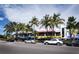 Street view of restaurants with outdoor seating and palm trees at 1336 Benjamin Franklin Dr # 1F, Sarasota, FL 34236